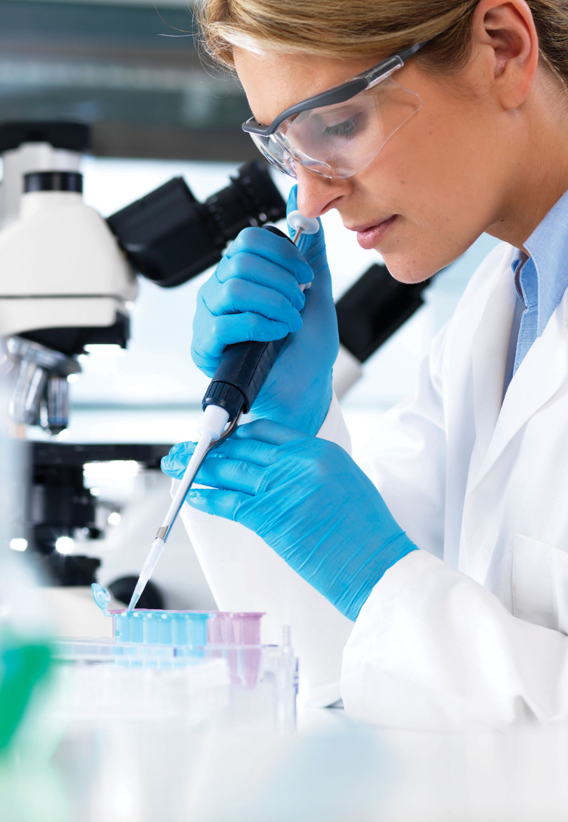 female researcher pipetting in lab